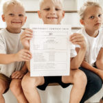 Kids on stairs holding an emergency contact info paper
