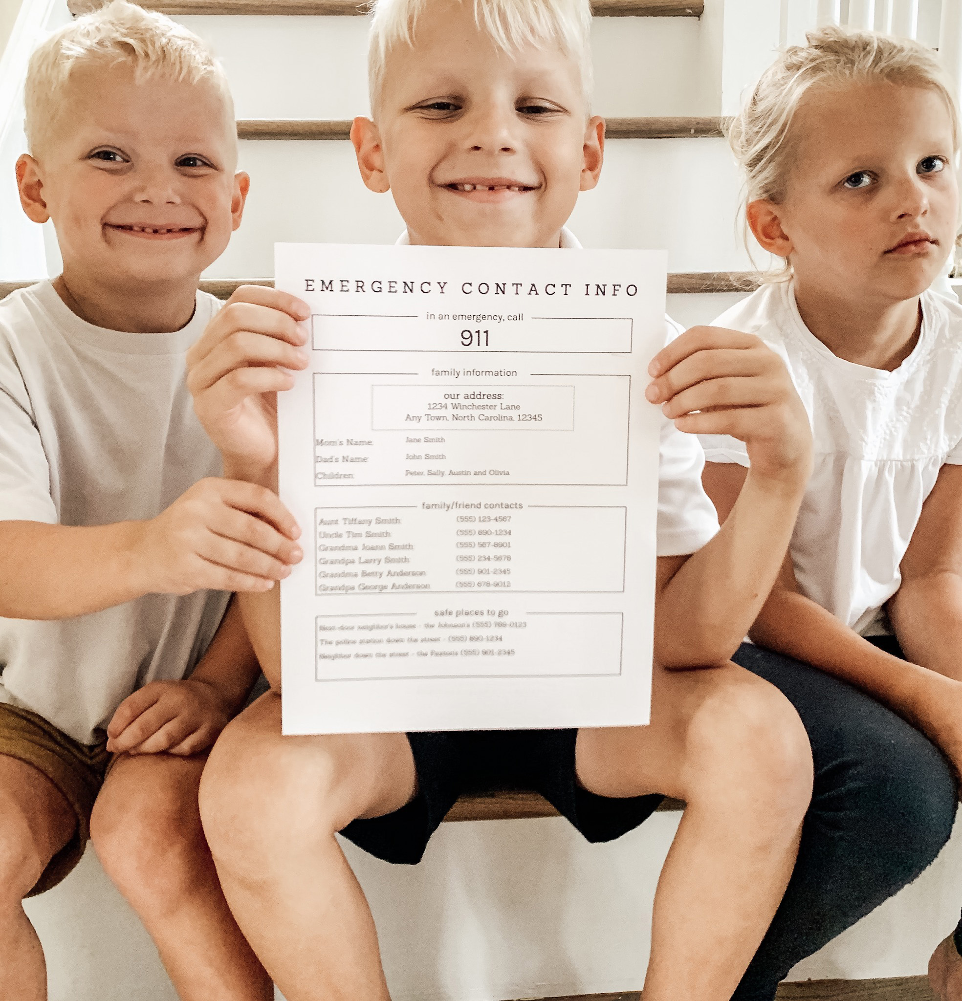Kids on stairs holding an emergency contact info paper