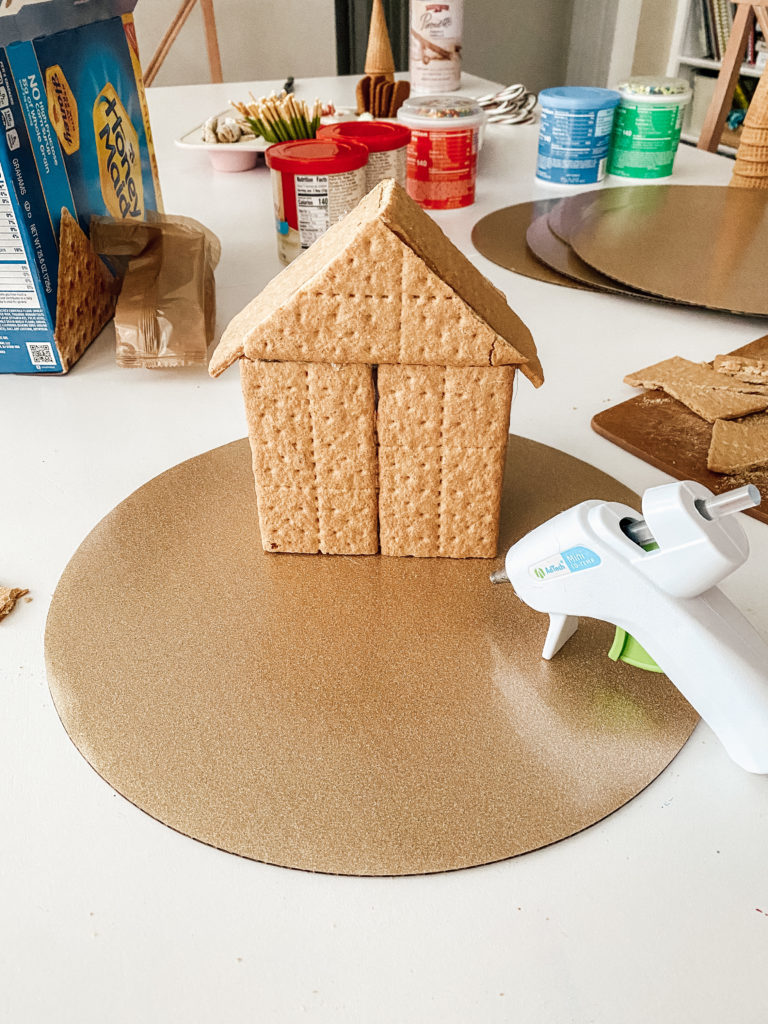 4. Glue the entire house to a cardboard cake round before decorating.