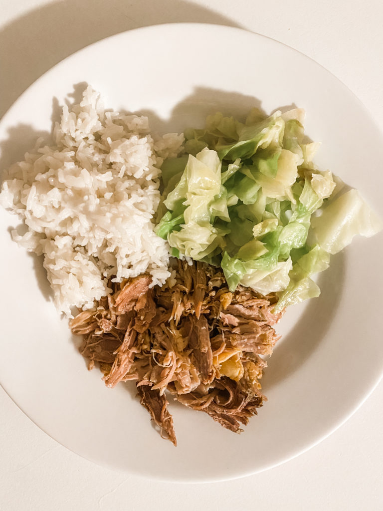 Kalua pork plated with coconut rice and cabbage