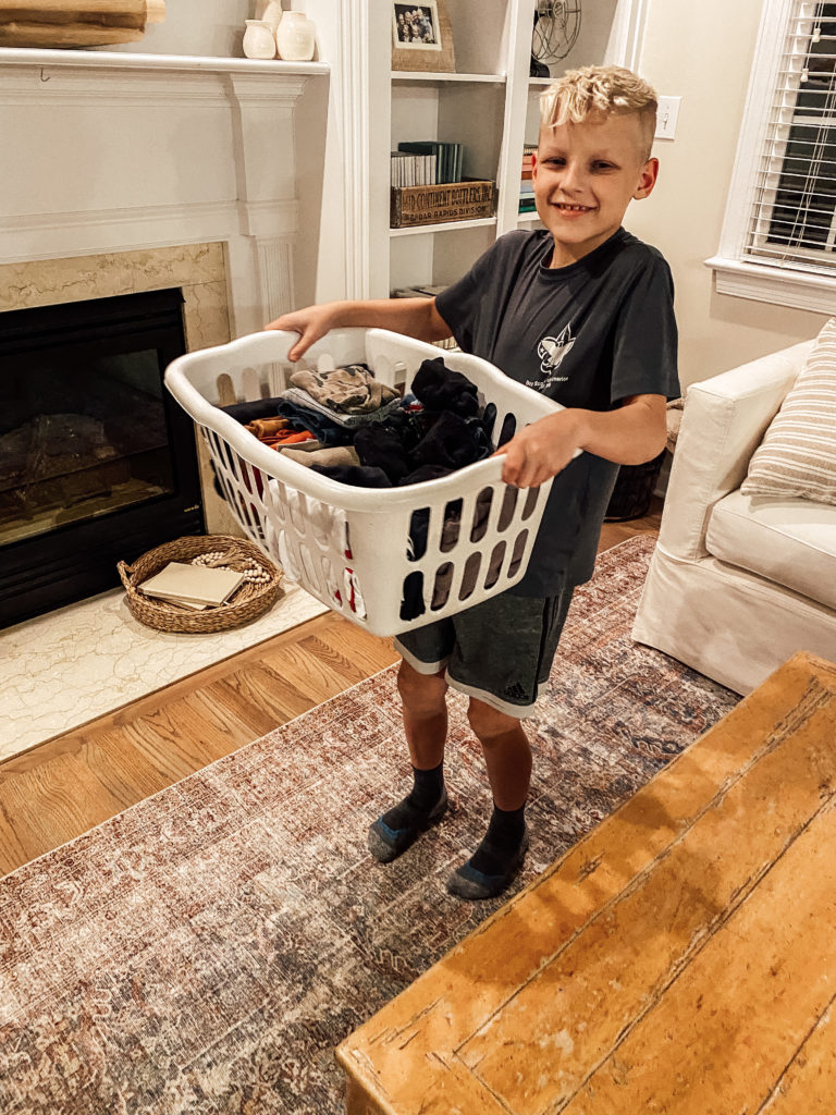 My son holding his laundry basket