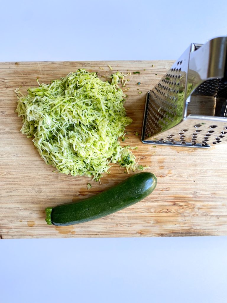 Zucchini shredded on a cutting board