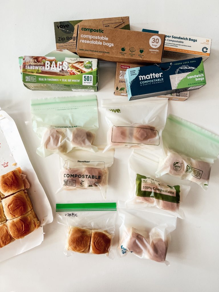A variety of compostable sandwich baggies with sandwiches in them on a countertop