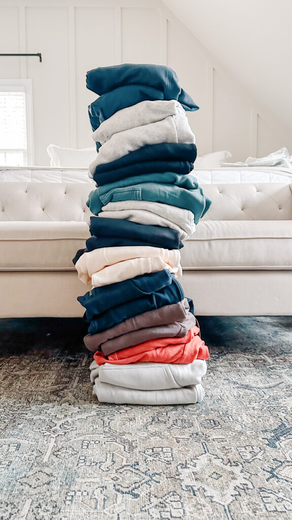 a stack of sweatsuits on the floor of Brittney's bedroom