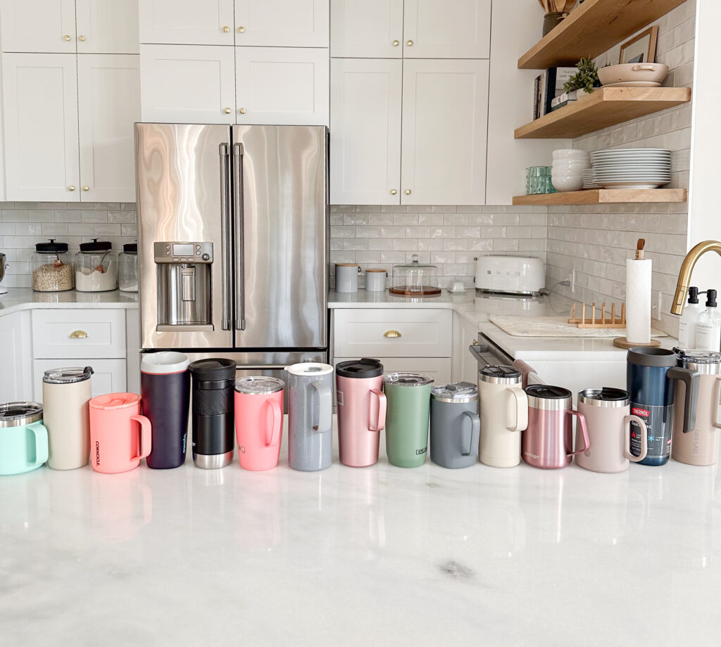 insulated mugs lined up on a countertop