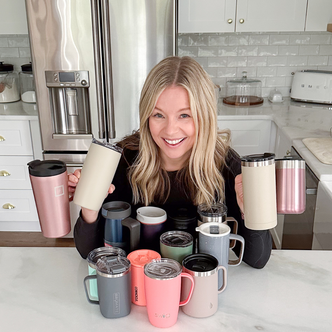 Brittney holding insulated mugs on the countertop
